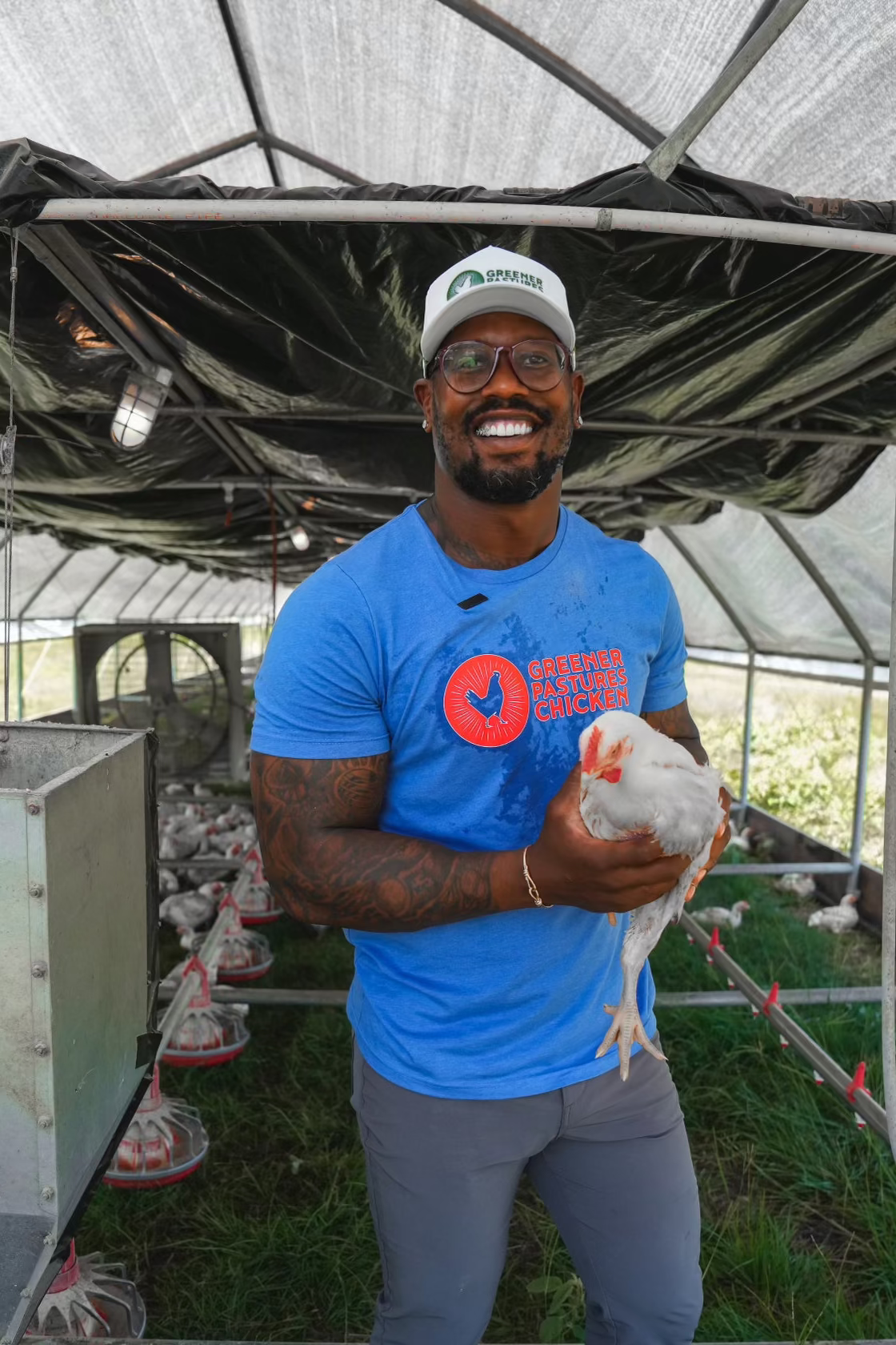 Von Miller holding chicken at Greener Pastures Chicken